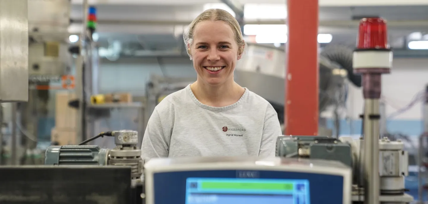 Glad tjej i produktionsanläggning för kosmetiska produkter hudvård